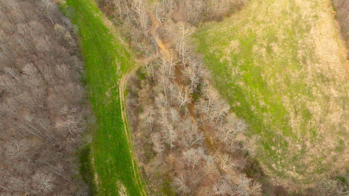 Aerial showing wooded acreage and access points