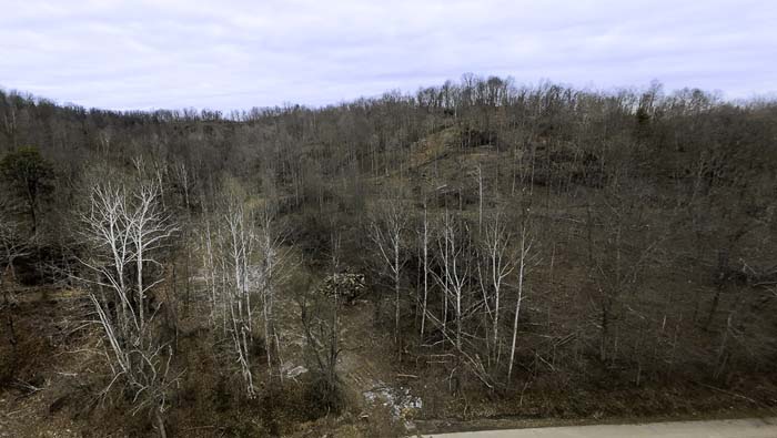 Ohio land with rock ledges and wooded surroundings