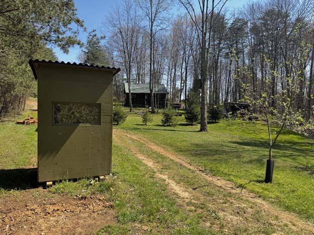Front view of cabin and open field