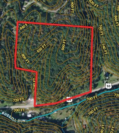 Rock formations and wooded terrain across acreage