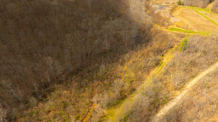 Scenic rural land with natural terrain and wooded setting