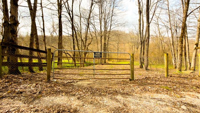 Wooded land parcel with trails and rolling countryside terrain