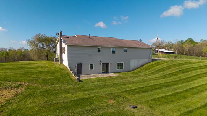 Ranch home with barns on rural acreage