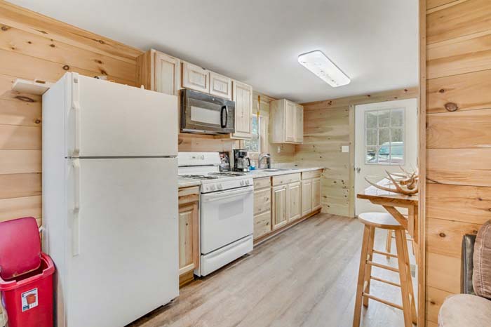 Aerial style ground view of rolling terrain and timber stand on Rife Road farm