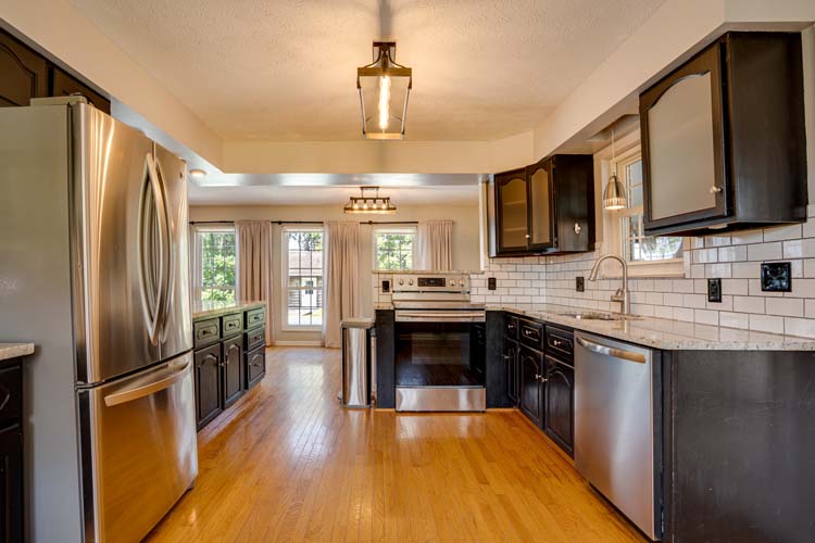 Overview of full property including yard, home, and outbuildings