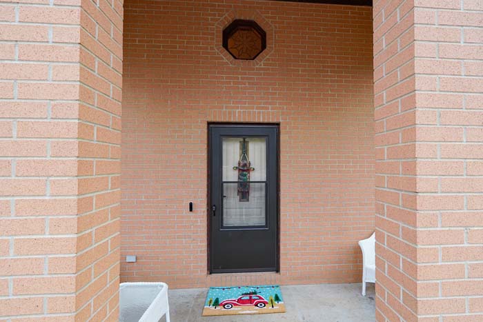 Side profile of home showing yard and wooded backdrop at 588 Ward Road