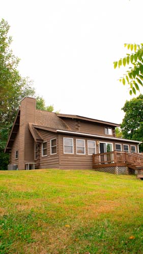 Cabin exterior and pond on private acreage