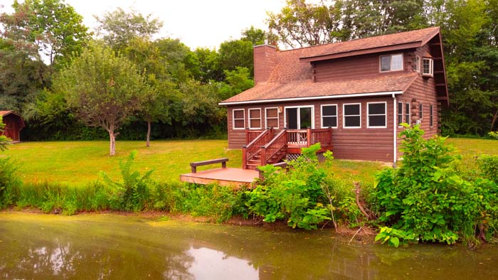 Cabin and pond surrounded by Highland County forest