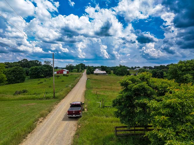 Corner lot view of open 5-acre tract