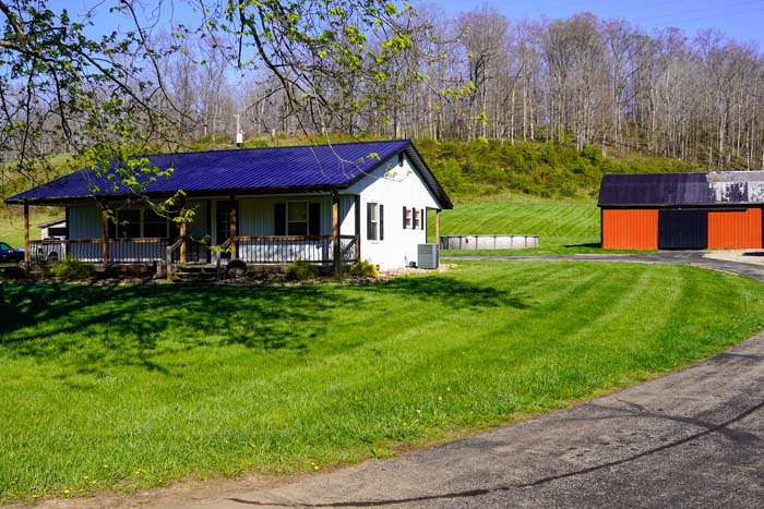 Aerial view of home and surrounding acreage