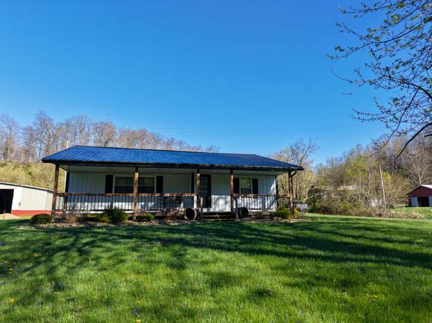 Front view of ranch style home with porch