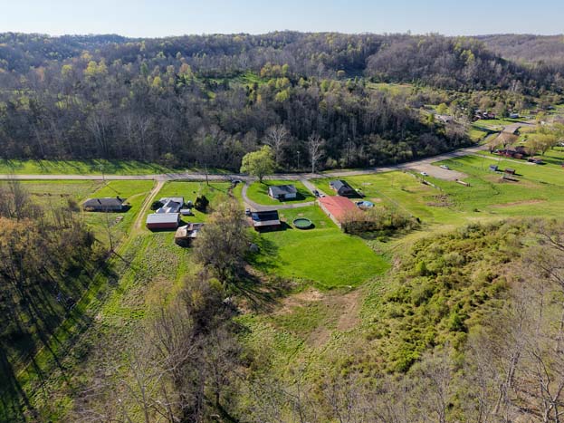 Wide aerial view of home and land