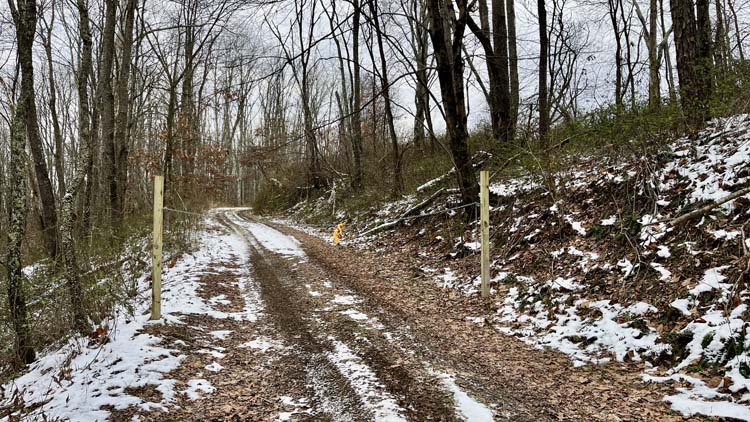 Ohio getaway property with open hilltop field wooded acres and creek access in Harrison County