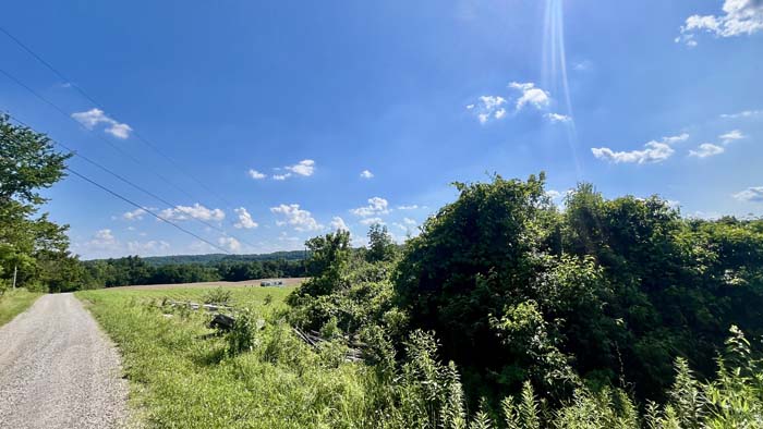 Camp-ready site with potential for home build.