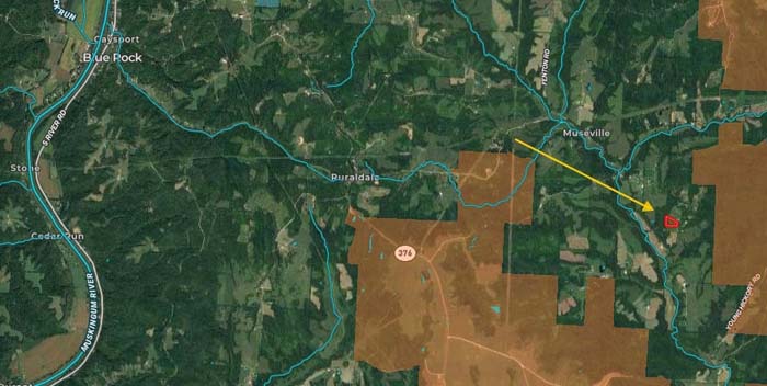 Gravel access road leading into secluded Ohio property.
