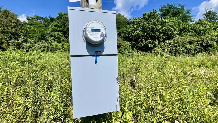 Older camper with electricity connection included on the property.