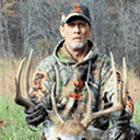 Craig Kelley posing with a buck