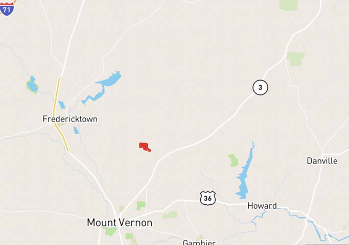 Open farm field with wooded edge