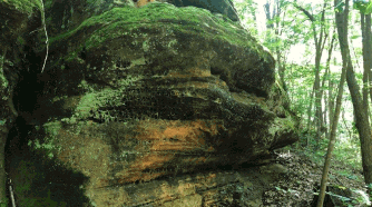 large rock formation with moss