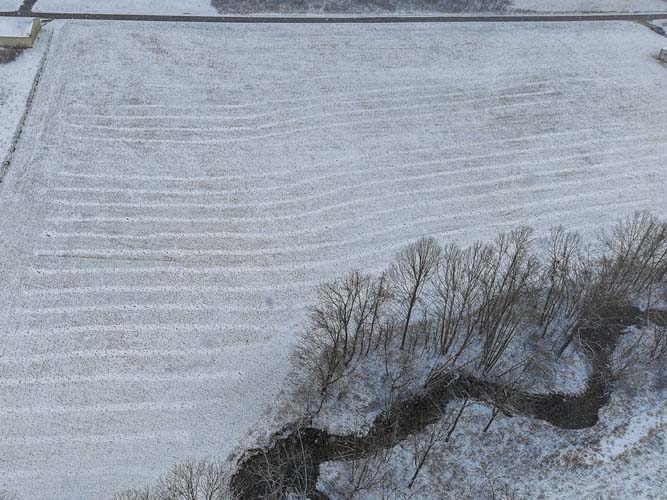Snow covered field with peaceful country surroundings near Wayne National Forest